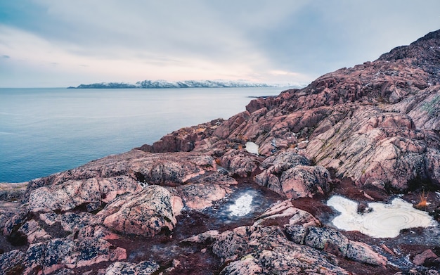 View to big cliff in arctic sky. Minimalist scenery with beautiful rockies. Awesome polar scenery with pointed rock.