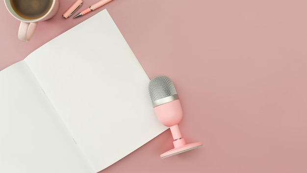 Above view blank notepad microphone and coffee cup on pink background Technology and audio equipment concept