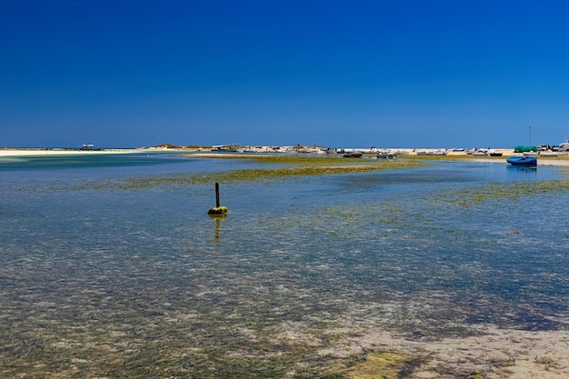 View of boats in the bay at low tide on the beach in the Mediterranean Sea on the island of Djerba Tunisia