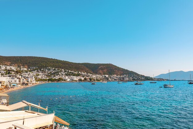 View on Bodrum city beach and bay with yachts at sunny day Mugla province Turkey Aegean sea Popular tourist summer destination in Turkey