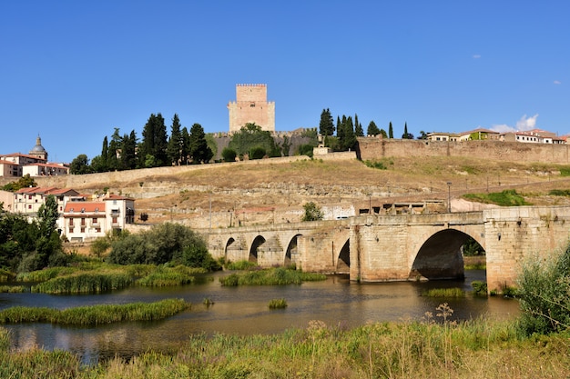 View of bridge and the Castle of Henry II of Castile (14th century) and River Agueda, Ciudad Rodrigo, Castile and Leon, Spain