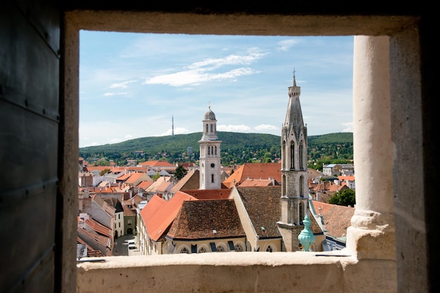 View of buildings against sky seen through window