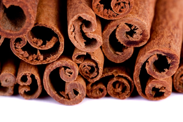 View of a bunch of cinnamon spice quills isolated on a white background.