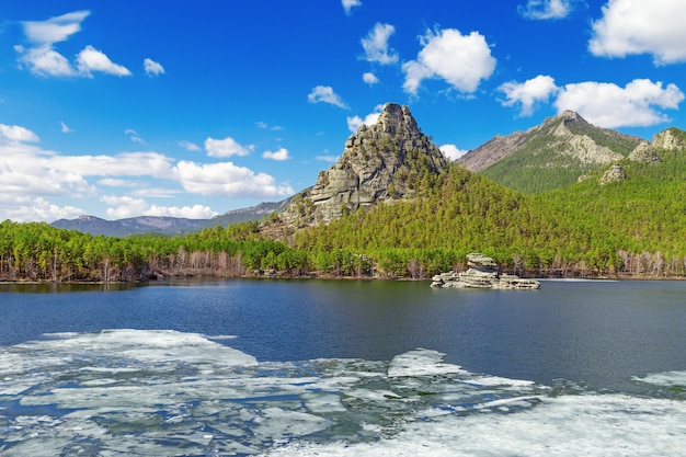 View of Burabai Lake  with ice and mysterious rock Zumbaktas. 