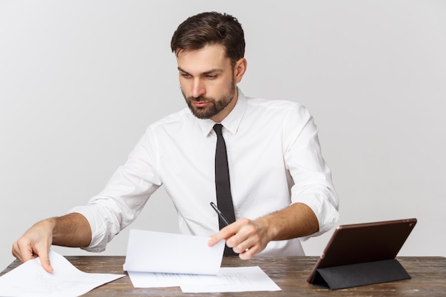 A view of a busy businessman signing a document in the office against white