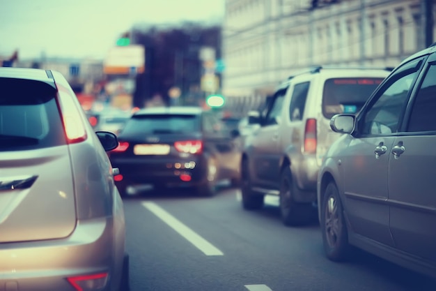 view of car in  traffic jam / rear view of the landscape from window in car, road with cars, lights and the legs of the cars  night view