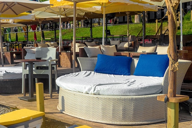 View of chic VIP chauffeurs in the form of a bed with blue pillows in a cafe on the seashore