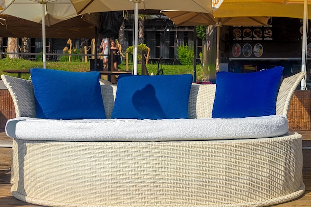 View of chic VIP chauffeurs in the form of a bed with blue pillows in a cafe on the seashore