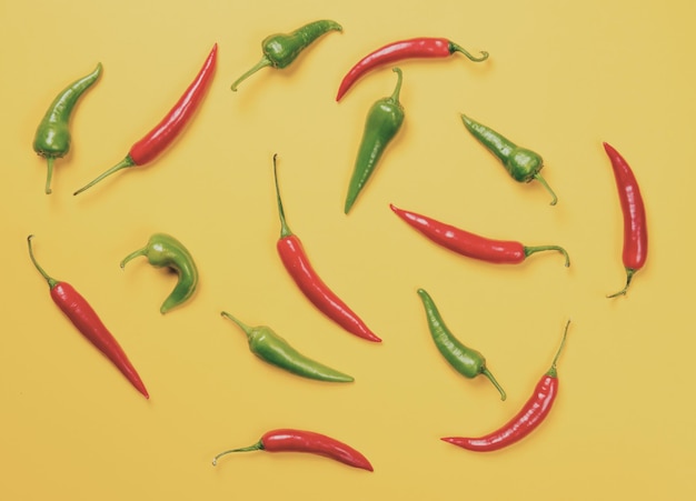 Above view at Chili pepper on yellow background