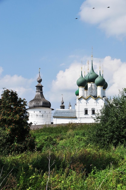 View of the churches. Churches of the Rostov Kremlin. Green domes of churches with crosses.