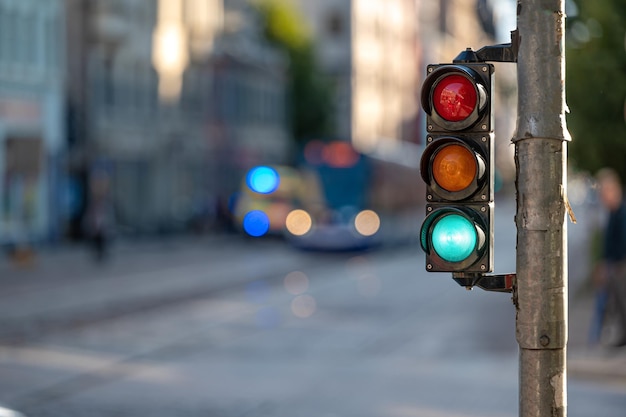 View of city traffic with traffic lights in the foreground a semaphore with a green light closeup