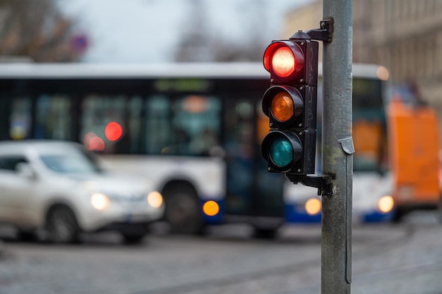 View of city traffic with traffic lights in the foreground a traffic light with a red light