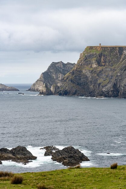 A view of the cliffs and the lighthouse from the cliffs of the isle of mull.