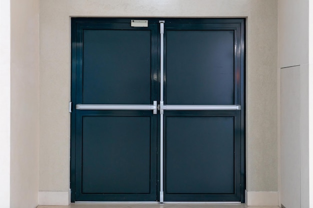 View of the closed door of the evacuation exit from the building during a fire or other cataclysm Emergency fire exit from the building Closed emergency exit door for quick evacuation