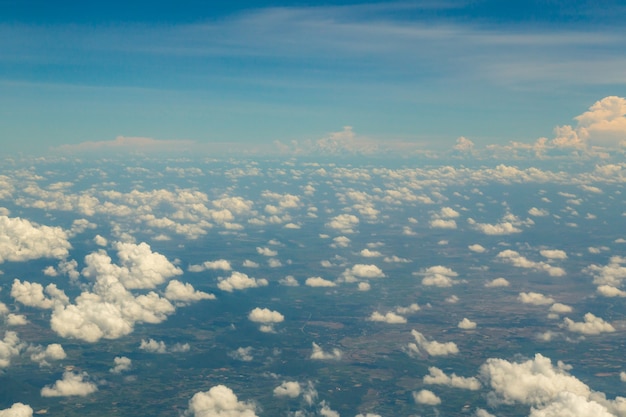 View above clouds and blue sky on airplane.