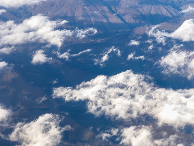 View of clouds and blue sky from an airplane window