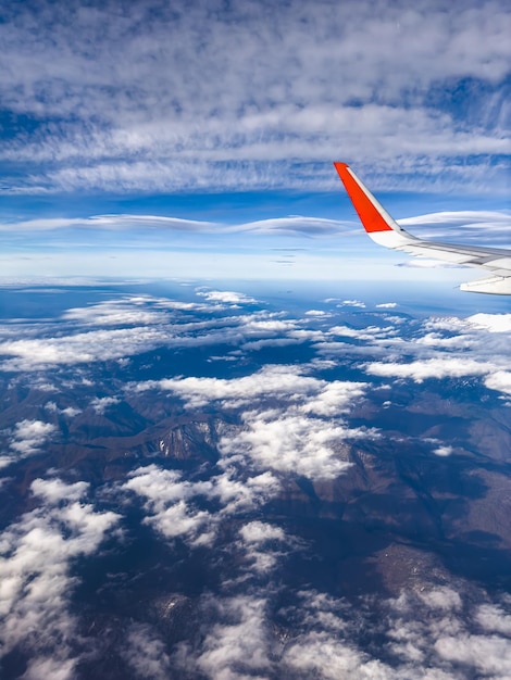 View of clouds and blue sky from an airplane window