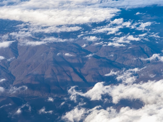 View of clouds and blue sky from an airplane window