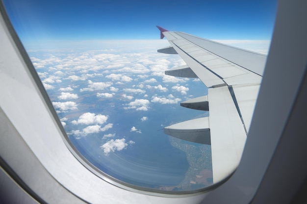 View of clouds and land from airplane window