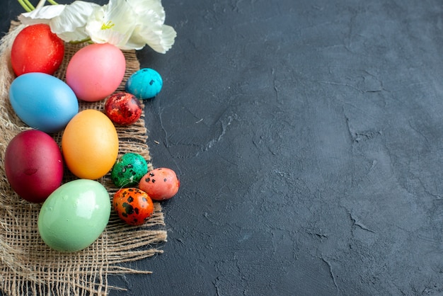 above view colored easter eggs on dark surface