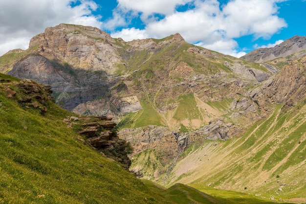 View of the corner of the green and the Salto de Tendenera waterfall in the Ripera valley Pyrenees