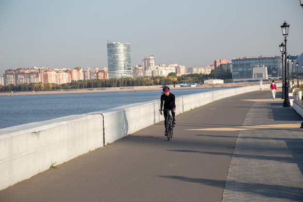 View of the cyclist exercising on the morning embankment