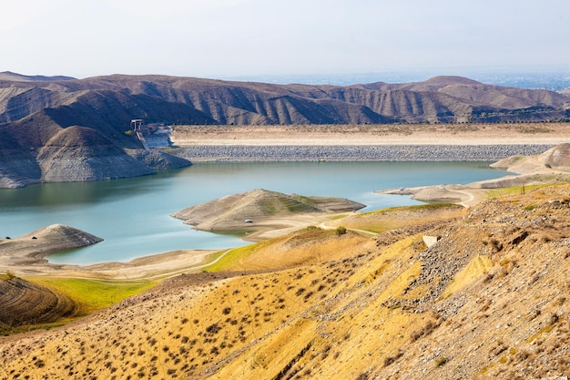 view of dam and river reservoir in mountains of Armenia on sunny autumn day