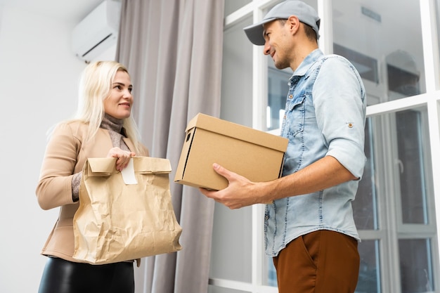 View of a Delivery man handing over a parcel to customer