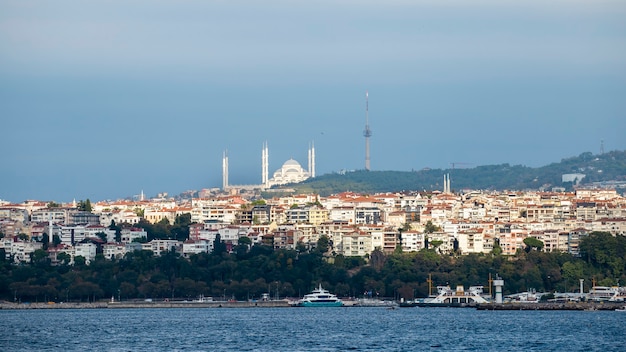 View of a district with residential buildings in Istanbul, Bosphorus Strait on the foreground, Sultan Ahmed Mosque in the distance, Turkey