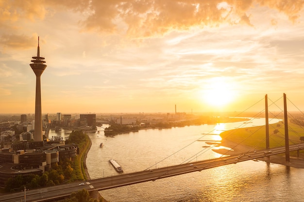 view of Dusseldorf at sunset with rhine tower (Rheinturm) and bridge. ideal for websites and magazines layouts