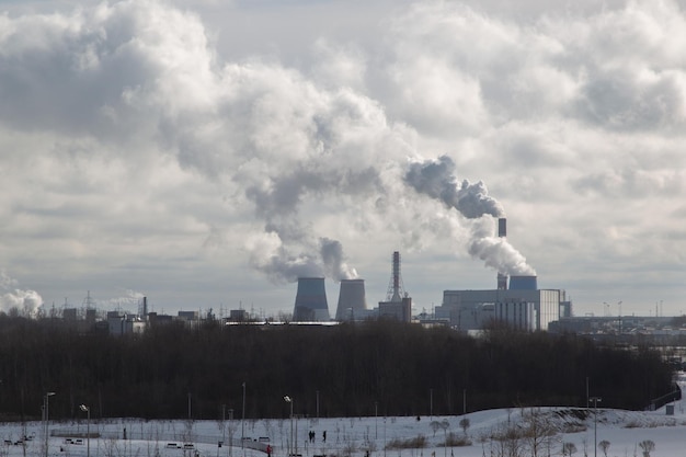 View of emissions from the pipes of a thermal power plant on a sunny day