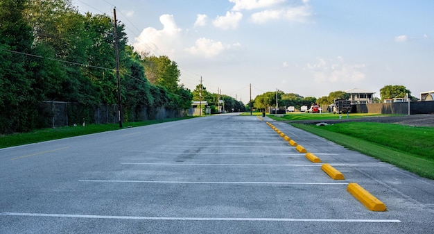 View of an empty parking lot under the blue sky with clouds