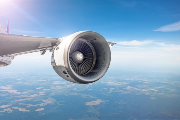 View of the engine on the wing of the aircraft during the flight in the sky