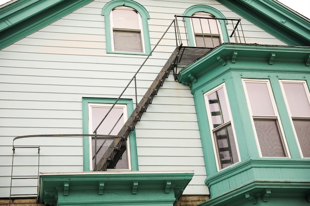 view of fire escapes on buildings and houses A series of metal ladders and platforms are visible