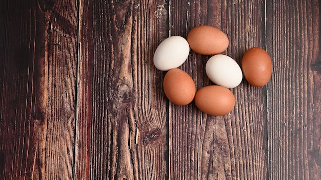 Above view of fresh eggs from organic farms on wooden table.