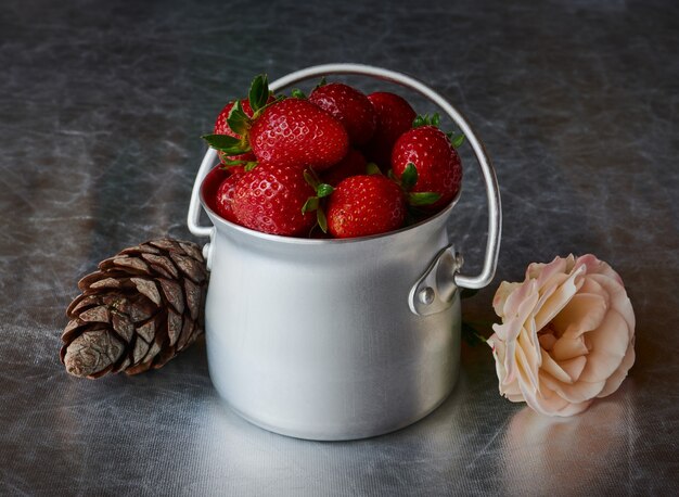 View on fresh strawberry in aluminum can on a silvery space