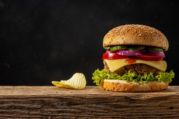 View of fresh tasty burger on wooden rustic table