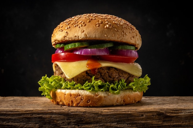 View of fresh tasty burger on wooden rustic table.