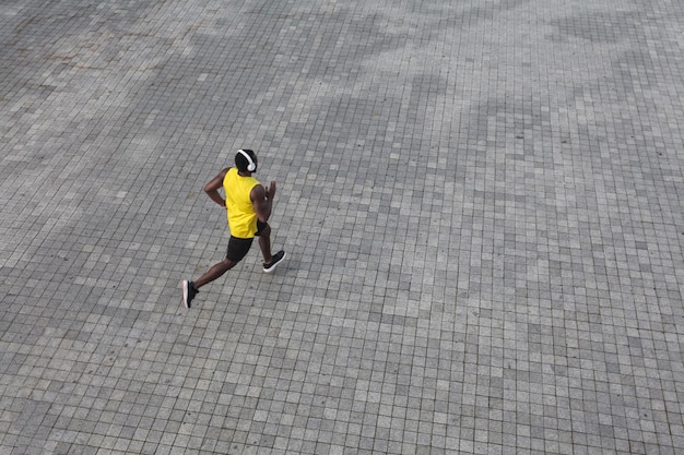 View from above african man running at the morning