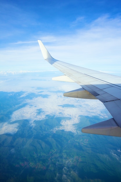 View from airplane window  airplane wing on the clouds