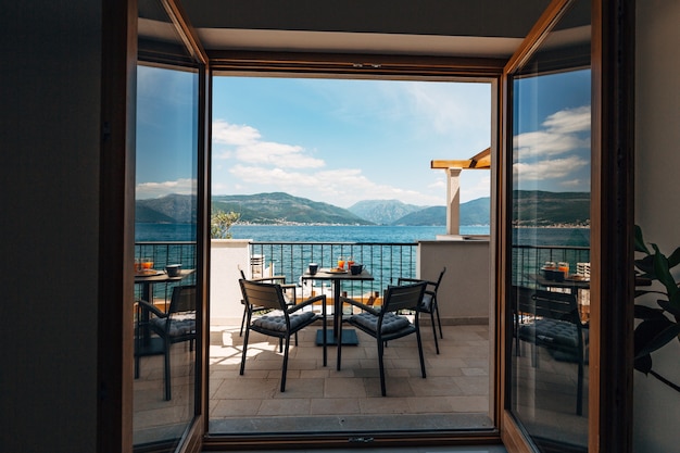 View from the apartment at sea balcony with garden furniture and breakfast on the table croissants