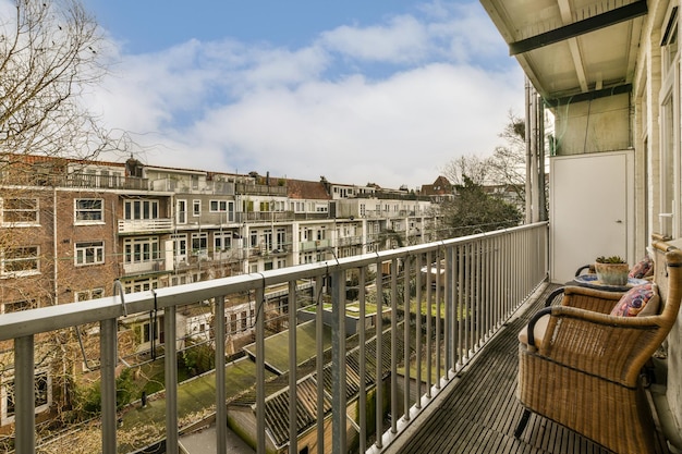 The view from the balcony of a apartment with chairs