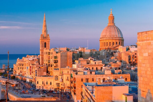 View from above of the domes of churches and roofs at beautiful sunset with church of our lady of mo