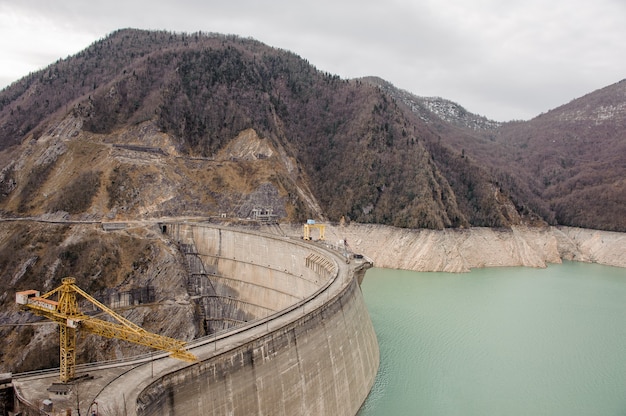 View from above on the Enguri Dam on the foreground of yellow construction crane