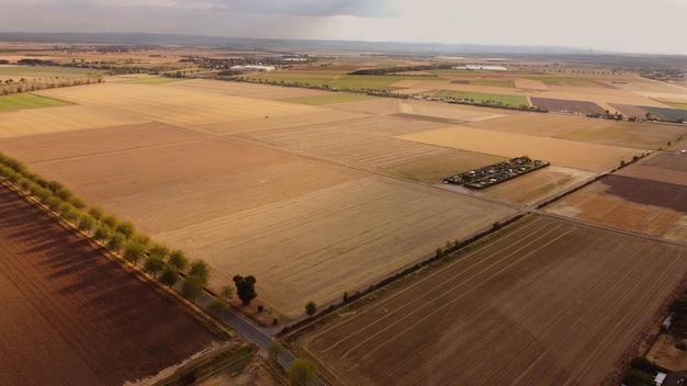 View from a height from a drone to the fields the village and the gloomy sky in autumn