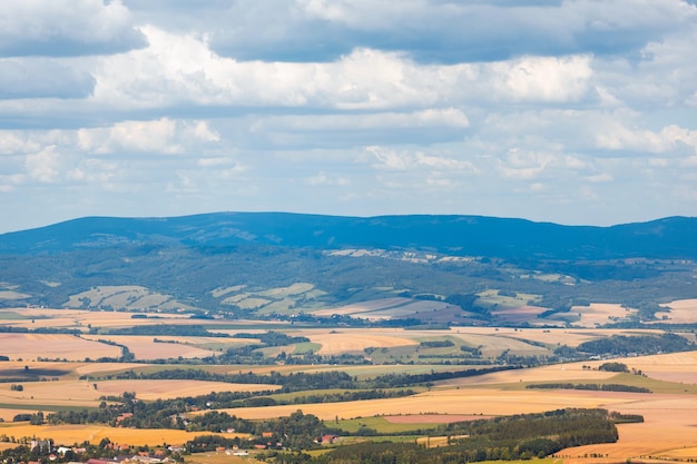 View from the height of a mountain range and many wheat fields rural landscape in the mountains