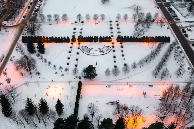 View from a height of a small snowcovered park in the evening