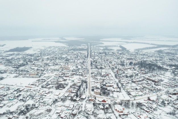 View from a height of a small village in winter Snowy village snowcovered houses and roads February weather in Ukraine