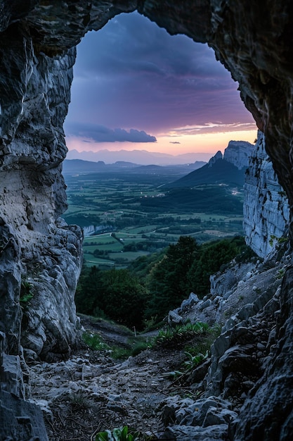 Photo view from inside of cave mountain landscape in the distance