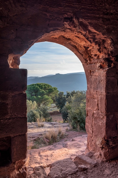 View from inside a ruined castle on the mountain at sunset